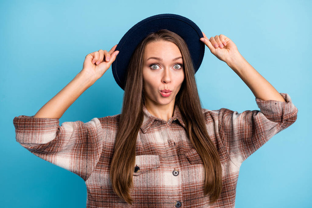 Photo of young lovely attractive beautiful shocked amazed surprised girl wear headwear isolated on blue color background - Valokuva, kuva