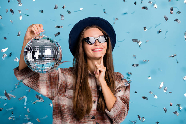 Photo of young happy positive smiling girl enjoying free time weekend hold disco ball isolated on blue color background - Fotoğraf, Görsel