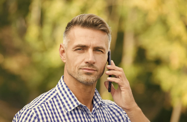 always available. cheerful man speak on cell phone. handsome businessman has groomed graying hair. mature guy is always online. agile business concept. communication with modern devices - Foto, Bild