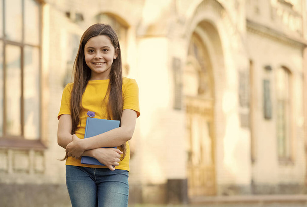 Little child girl back to school hold textbook, free courses concept - Valokuva, kuva