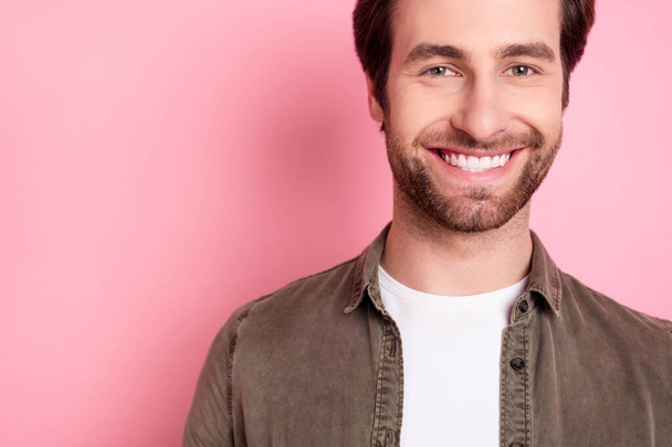 Cropped view portrait of attractive cheerful guy copy empty space isolated over pink pastel color background - Foto, Bild