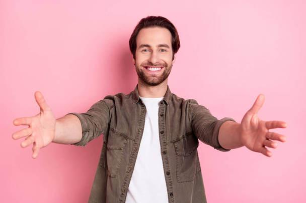 Photo of impressed cute young man wear brown shirt open arms wanting hug you smiling isolated pink color background - Foto, Bild