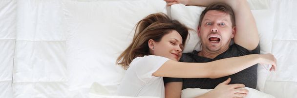 Woman sleeping on man in bed top view - Photo, Image
