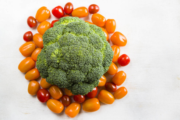 A top view of fresh cherry tomatoes and broccoli isolated on a white backgroundigh angle view - Φωτογραφία, εικόνα