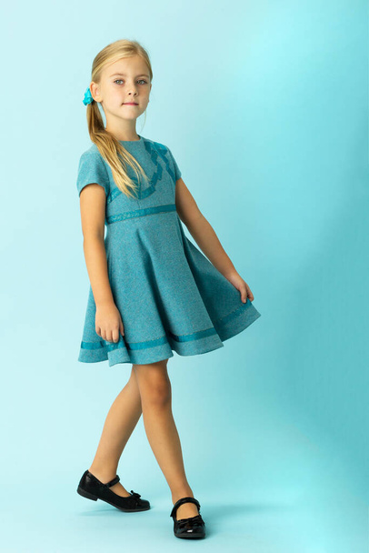 Cute blonde girl in stylish blue dress - Foto, imagen
