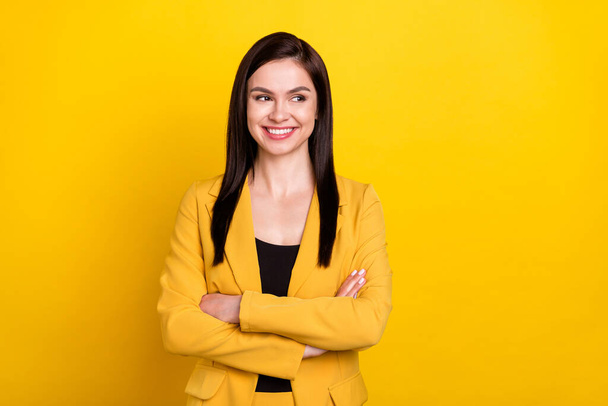 Photo of young woman happy positive smile confident crossed hands look empty space isolated over yellow color background - Foto, imagen