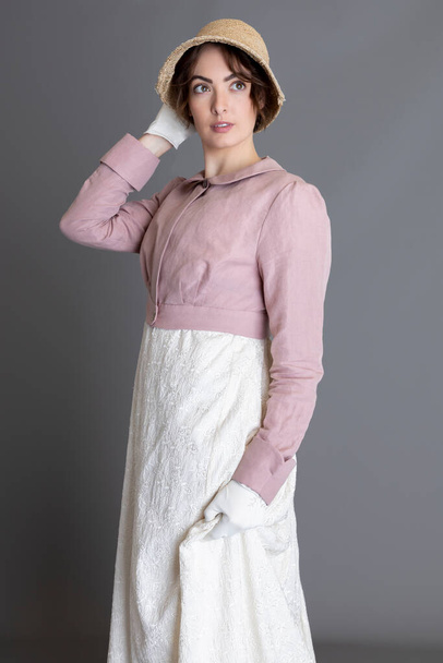 Regency woman wearing an embroidered cream dress and a pink linen spencer - Фото, изображение