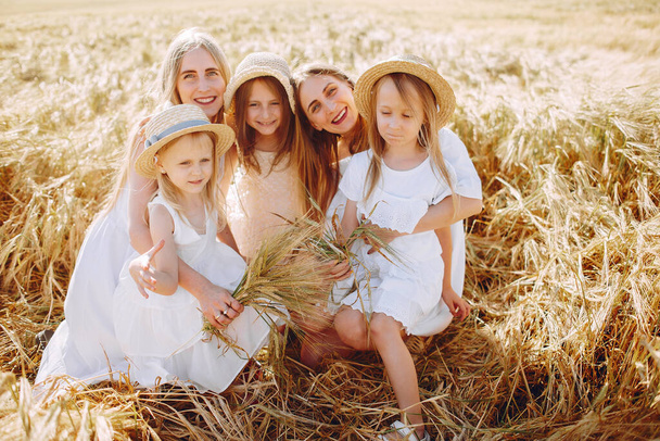 Mothers with daughters playing in a autumn field - Фото, изображение