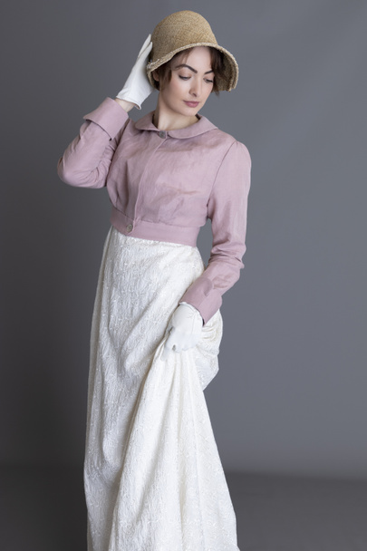 Regency woman wearing an embroidered cream dress and a pink linen spencer - Фото, зображення