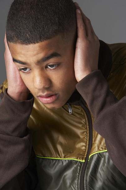 Teenage Boy Covering Ears With Hands - Valokuva, kuva