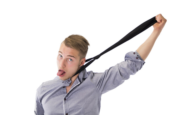 Funny young man hanging himself with neck-tie - Fotó, kép