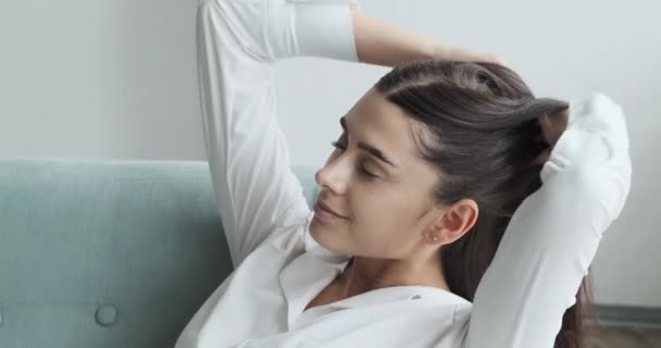 Young woman with her eyes closed resting alone in a cozy living room,  - Filmagem, Vídeo