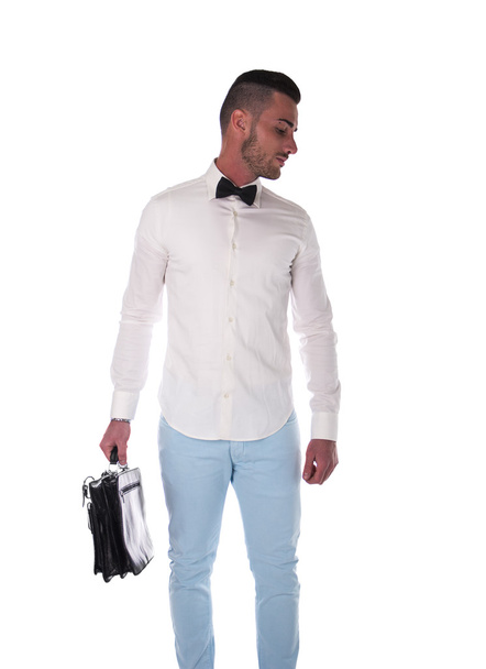 Handsome young businessman with casual shirt, bowtie and suitcase - Foto, Imagem