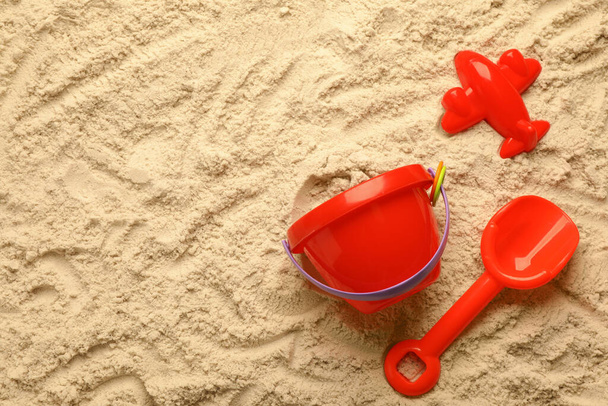 Flat lay of beach toy kit on sand, space for text. Outdoor play - Fotó, kép
