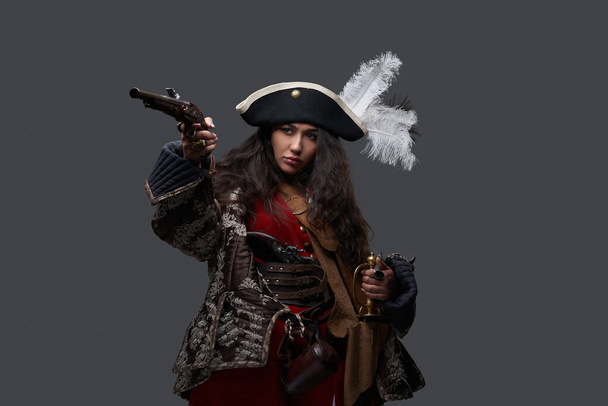 Pirate woman dressed in medieval clothing with gun - Fotó, kép