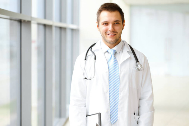 Male doctor standing in the modern clinic. Perfect medical service in the hospital. Medicine and healthcare concept. - Photo, Image