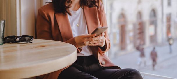 femme assise dans le café textos sur le téléphone recadrage fermer l'espace de copie - Photo, image