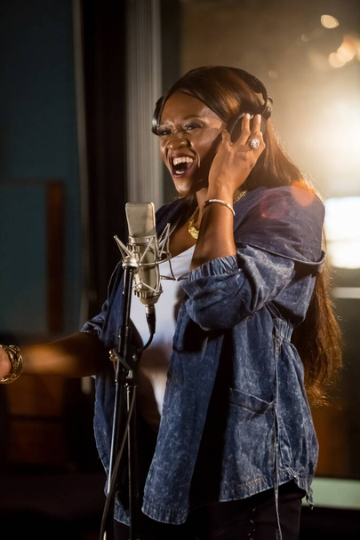 JOHANNESBU, SOUTH AFRICA - Jan 18, 2021: Johannesburg, South Africa - April 29, 2015: Waje Nigerian singer recording vocal part on Afro-pop song in studio - 写真・画像