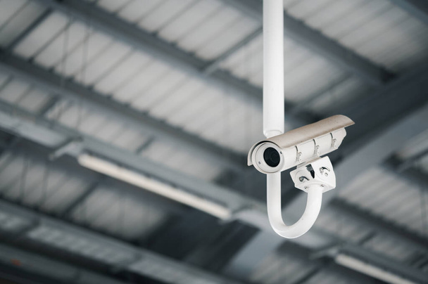 Modern CCTV security system on sky background Smart camera theft protection. - Fotó, kép