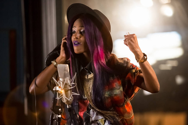 JOHANNESBU, SOUTH AFRICA - Jan 18, 2021: Johannesburg, South Africa - April 29, 2015: Vanessa Mdee, Tanzania singer recording vocal part on Afro-pop song in studio - Photo, image