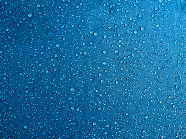 Water drops on waterproof membrane fabric. Morning dew on tent. - Photo, Image