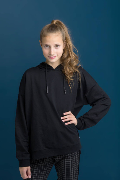 Pretty teenage girl in black hoodie. - Fotografie, Obrázek