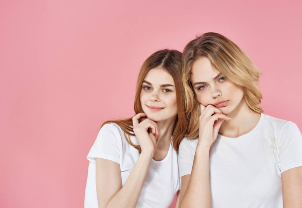two cute girlfriends in white t-shirts emotions friendship fashion - Fotoğraf, Görsel