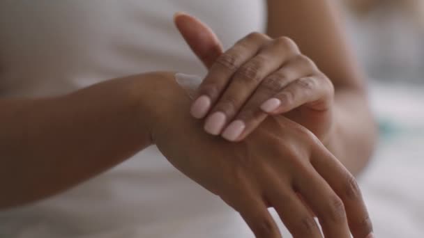 Junge Afroamerikanerin trägt verwöhnende Schaumcreme auf die Hände auf, Sonnenschutzkonzept, Nahaufnahme - Filmmaterial, Video