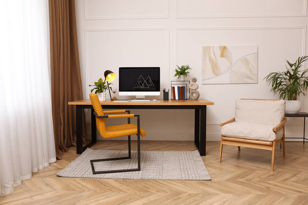 Room interior with comfortable workplace. Modern computer on wooden desk - Foto, Imagem