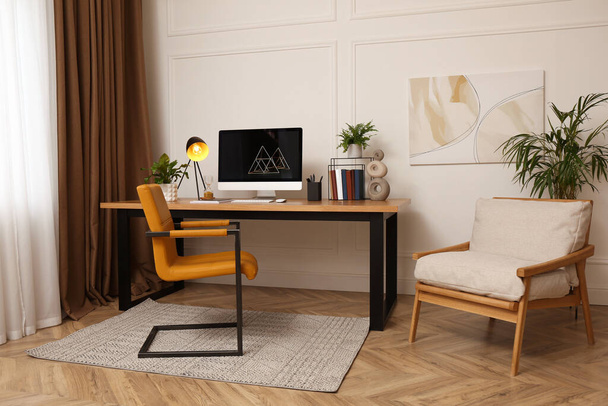 Room interior with comfortable workplace. Modern computer on wooden desk - Foto, Bild