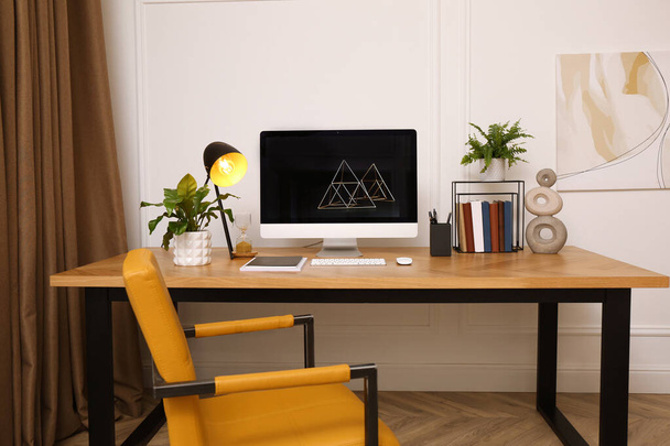 Room interior with comfortable workplace. Modern computer on wooden desk - 写真・画像