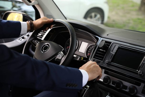 Man driving his car, closeup view of hands on steering wheel - Foto, Imagen