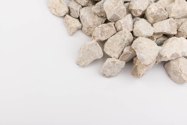 Gray small rocks ground texture isolated on white background. Small road stone. Gravel pebbles stone. crushed granite gravel, close up.  - Фото, изображение