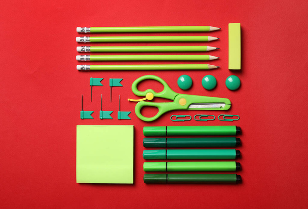 Flat lay composition with stationery on red background - Photo, image