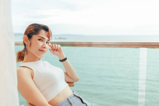 Close up of woman relax on the hotel balcony with sea view in summer. - Foto, Imagen