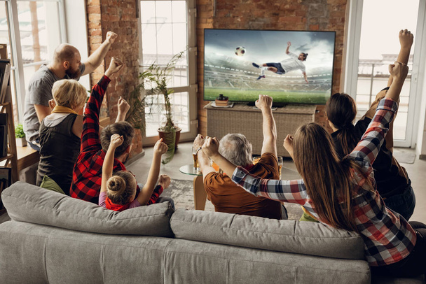 Excited, happy big family team watch sport match together on the couch at home - Zdjęcie, obraz