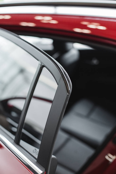 glass in the back door of a red car  - Φωτογραφία, εικόνα