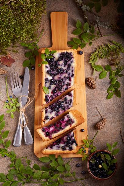 Tart with blueberries and sour cream filling. Sweet homemade dessert with wild forest berries. - Photo, image