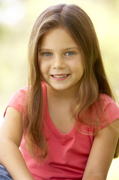 Portrait Of Young Girl Sitting In Park - Foto, imagen