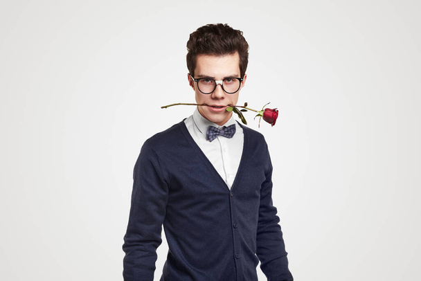 Confident nerdy man with rose in mouth - Zdjęcie, obraz