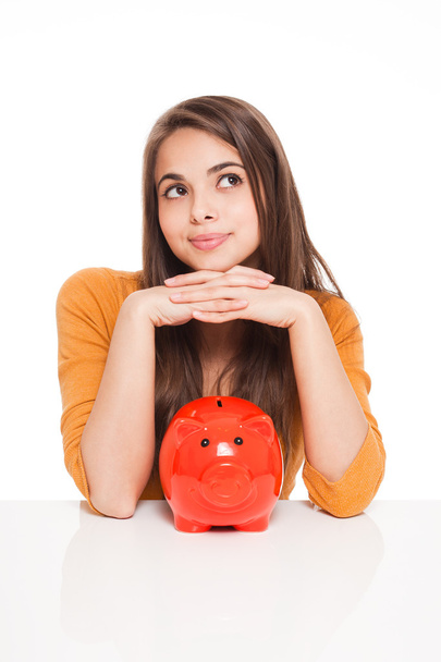 Brunette with piggy bank. - Photo, image