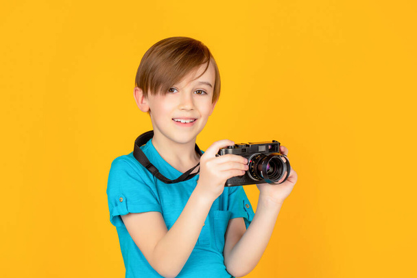 Baby boy with camera. Cheerful smiling child holding a cameras. Little boy on a taking a photo using a vintage camera. Child in studio with professional camera. Boy using a cameras - Photo, image
