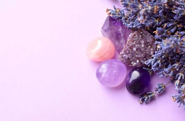 Beautiful amethyst crystals and round rose quartz stone with dry lavender bouquet. Magic amulets. Copy space - Valokuva, kuva
