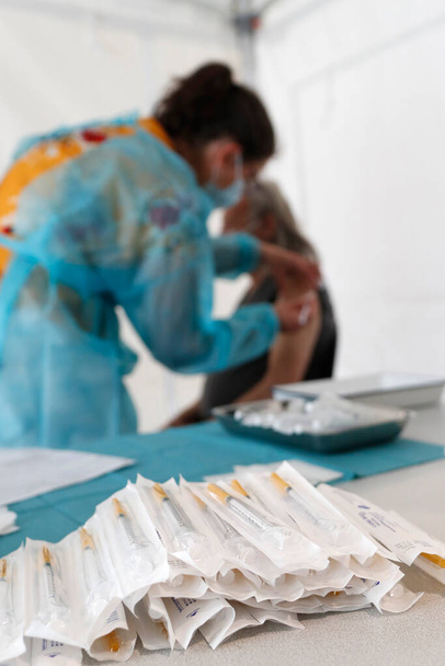 COVID-19 vaccination center.  Man receiving Covid 19 vaccination.   Saint-Gervais. France.  - Foto, immagini
