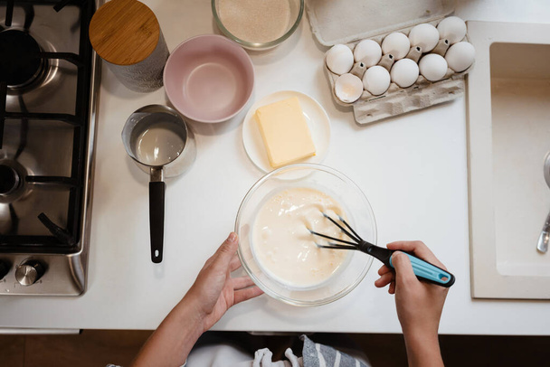 Caucasian woman making pancake dough at home kitchen - Zdjęcie, obraz