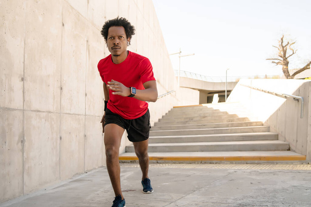 Athletic man running and doing exercise outdoors. - Φωτογραφία, εικόνα