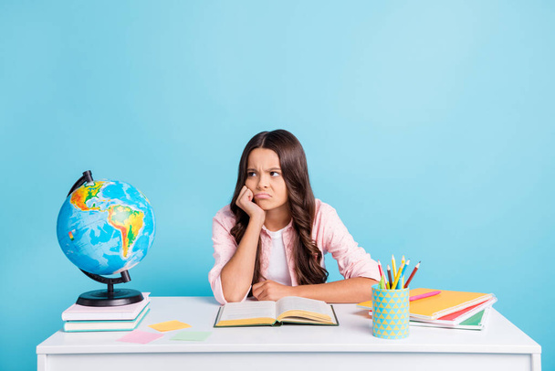 Photo of young unhappy upset negative annoyed girl look copyspace tired of studying isolated on blue color background - Fotografie, Obrázek