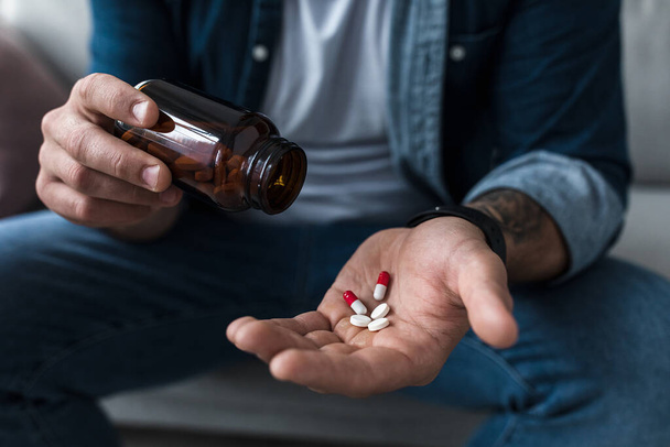 Χέρια γεμάτα λευκά χάπια σε άνδρες ασθενείς παλάμη. Υγεία, θεραπεία, φάρμακα και κατάθλιψη, πόνος και αυτοκτονία - Φωτογραφία, εικόνα
