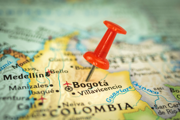 Lokalizacja Bogota city in Colombia, red push pin on the travel map, marker and point closeup, tourism and trip concept, Ameryka Południowa  - Zdjęcie, obraz