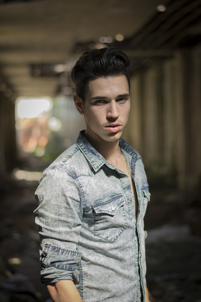 Handsome black haired young man in denim shirt - Foto, afbeelding